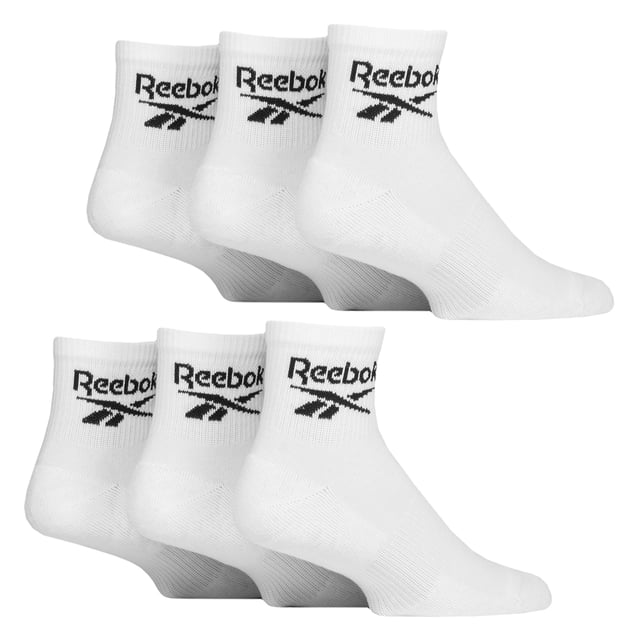 Reebok - 6 Pack Men's & Ladies Core Cotton Ankle Socks:  Reebok Core Cotton Ankle Socks are meticulously designed for everyday comfort, featuring an innovative ankle fit that stays discreetly hidden for that desired sockless appearance. Ideal for those who prefer an unobtrusive and minimalist style, these socks seamlessly blend into any outfit while maintaining maximum comfort throughout the day. These socks offer a great balance of softness, durability, and flexibility. Additionally, supportive elastic arch bands are incorporated into the design, offering a secure, snug fit around the foot's natural arch. These bands help to prevent sock slippage during movement, ensuring the socks stay in place without bunching or sliding down, even during intense physical activity. These ankle socks are made from a soft, smooth cotton blend that ensures breathability and a cool, comfortable feel all day long. The perfect blend of comfort and functionality, these socks are ideal for any activity. These everyday socks are crafted for enhanced comfort and durability, featuring soft terry cushioning strategically placed in the soles, heels, and toes. This extra layer of padding provides superior shock absorption, making them perfect for long hours of wear. They are constructed from a blend of 61% Cotton, 35% Polyester, 3% Elastane, and 1% Polyamide, they come in a 6 pair pack and are available in classic Black or White. These socks come in 3 sizes: 6-8, 8-10 and 10-12 UK are also machine washable at 40°, making them easy to care for. Extra Product Details: Reebok Core Ankle Socks Cotton Rich Fibres Invisible Under-Ankle Design Arch Support Bands Seamless Toe Soft & Breathable 6 Pairs Per Pack Machine Washable