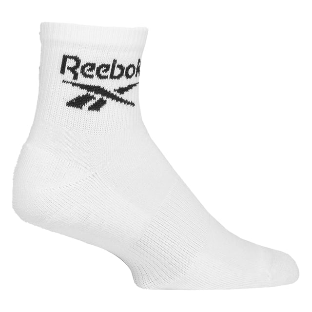 Reebok - 6 Pack Men's & Ladies Core Cotton Ankle Socks:  Reebok Core Cotton Ankle Socks are meticulously designed for everyday comfort, featuring an innovative ankle fit that stays discreetly hidden for that desired sockless appearance. Ideal for those who prefer an unobtrusive and minimalist style, these socks seamlessly blend into any outfit while maintaining maximum comfort throughout the day. These socks offer a great balance of softness, durability, and flexibility. Additionally, supportive elastic arch bands are incorporated into the design, offering a secure, snug fit around the foot's natural arch. These bands help to prevent sock slippage during movement, ensuring the socks stay in place without bunching or sliding down, even during intense physical activity. These ankle socks are made from a soft, smooth cotton blend that ensures breathability and a cool, comfortable feel all day long. The perfect blend of comfort and functionality, these socks are ideal for any activity. These everyday socks are crafted for enhanced comfort and durability, featuring soft terry cushioning strategically placed in the soles, heels, and toes. This extra layer of padding provides superior shock absorption, making them perfect for long hours of wear. They are constructed from a blend of 61% Cotton, 35% Polyester, 3% Elastane, and 1% Polyamide, they come in a 6 pair pack and are available in classic Black or White. These socks come in 3 sizes: 6-8, 8-10 and 10-12 UK are also machine washable at 40°, making them easy to care for. Extra Product Details: Reebok Core Ankle Socks Cotton Rich Fibres Invisible Under-Ankle Design Arch Support Bands Seamless Toe Soft & Breathable 6 Pairs Per Pack Machine Washable