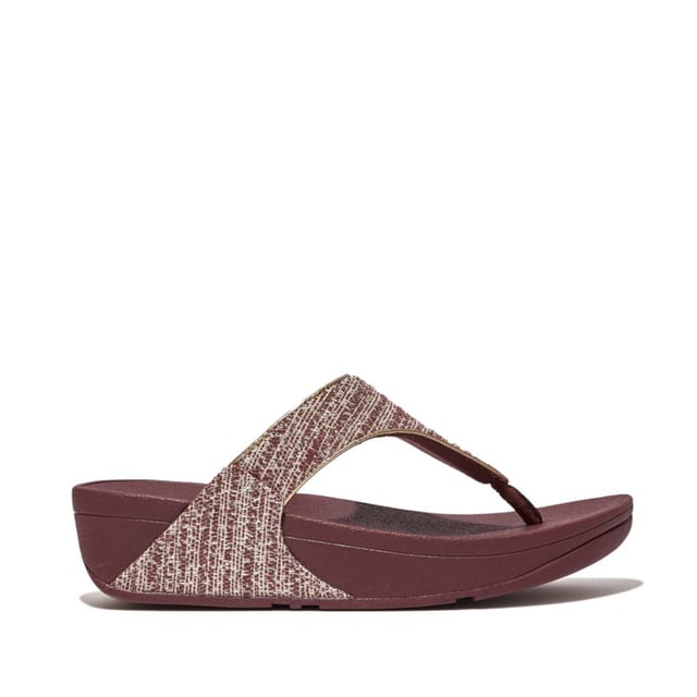 Women's Fit Flop Lulu Shimmerweave Toe-Post Sandals in Brown FitFlop's bestselling Lulu sandals boast a timeless triangular vamp softly padded uppers and a soft microfibre toe post. Featuring FitFlop's Microwobbleboard™ midsoles for unbeatable comfort. This season in a sparkling finely ribbed glitz mesh (with metallic pearlised faux-leather side panels for extra lustre). Beautiful. Versatile. The sophisticated shimmer means these work with multiple looks - dress yours up or down wear day through to night.Ergonomically engineered to help optimize your body's alignment natural movement & energyLight pressure-diffusing Microwobbleboard midsole - triple-density cushioning follows 3 footstep stages (firm heel-soft middle-medium at toes)Natural arch supportAverage to wide fitGrip level 1 - everyday use-road treadThese shoes have been granted the APMA* Seal of Acceptance for footwear found to promote good foot health*American Podiatric Medical Association