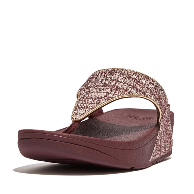 Women's Fit Flop Lulu Shimmerweave Toe-Post Sandals in Brown FitFlop's bestselling Lulu sandals boast a timeless triangular vamp softly padded uppers and a soft microfibre toe post. Featuring FitFlop's Microwobbleboard™ midsoles for unbeatable comfort. This season in a sparkling finely ribbed glitz mesh (with metallic pearlised faux-leather side panels for extra lustre). Beautiful. Versatile. The sophisticated shimmer means these work with multiple looks - dress yours up or down wear day through to night.Ergonomically engineered to help optimize your body's alignment natural movement & energyLight pressure-diffusing Microwobbleboard midsole - triple-density cushioning follows 3 footstep stages (firm heel-soft middle-medium at toes)Natural arch supportAverage to wide fitGrip level 1 - everyday use-road treadThese shoes have been granted the APMA* Seal of Acceptance for footwear found to promote good foot health*American Podiatric Medical Association