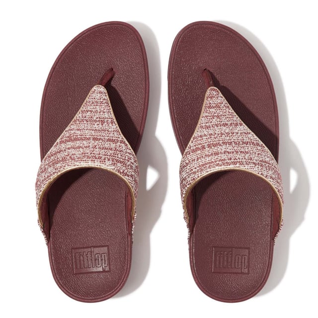 Women's Fit Flop Lulu Shimmerweave Toe-Post Sandals in Brown FitFlop's bestselling Lulu sandals boast a timeless triangular vamp softly padded uppers and a soft microfibre toe post. Featuring FitFlop's Microwobbleboard™ midsoles for unbeatable comfort. This season in a sparkling finely ribbed glitz mesh (with metallic pearlised faux-leather side panels for extra lustre). Beautiful. Versatile. The sophisticated shimmer means these work with multiple looks - dress yours up or down wear day through to night.Ergonomically engineered to help optimize your body's alignment natural movement & energyLight pressure-diffusing Microwobbleboard midsole - triple-density cushioning follows 3 footstep stages (firm heel-soft middle-medium at toes)Natural arch supportAverage to wide fitGrip level 1 - everyday use-road treadThese shoes have been granted the APMA* Seal of Acceptance for footwear found to promote good foot health*American Podiatric Medical Association