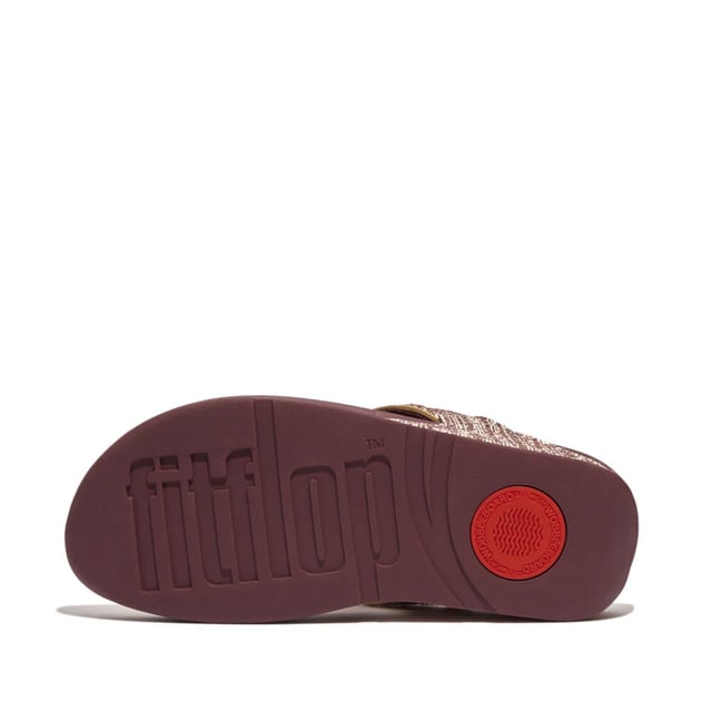 Women's Fit Flop Lulu Shimmerweave Toe-Post Sandals in Brown FitFlop's bestselling Lulu sandals boast a timeless triangular vamp softly padded uppers and a soft microfibre toe post. Featuring FitFlop's Microwobbleboard™ midsoles for unbeatable comfort. This season in a sparkling finely ribbed glitz mesh (with metallic pearlised faux-leather side panels for extra lustre). Beautiful. Versatile. The sophisticated shimmer means these work with multiple looks - dress yours up or down wear day through to night.Ergonomically engineered to help optimize your body's alignment natural movement & energyLight pressure-diffusing Microwobbleboard midsole - triple-density cushioning follows 3 footstep stages (firm heel-soft middle-medium at toes)Natural arch supportAverage to wide fitGrip level 1 - everyday use-road treadThese shoes have been granted the APMA* Seal of Acceptance for footwear found to promote good foot health*American Podiatric Medical Association