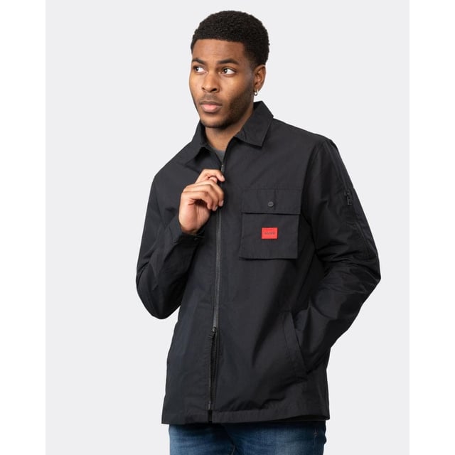 A trend-driven zip-up overshirt by HUGO Menswear in cotton-rich canvas, featuring a zipped pocket at the sleeve and a red logo label.
Regular fitCamp collarPatch chest pocketsSquared cuffs
75% Cotton, 25% Polyamide
50482701
 
 