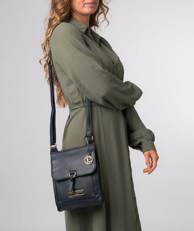 The 'Naomi' cross body bag from Pure Luxuries London is crafted from leather that has a soft pebble grain finish. The fold over top conceals the 100% untreated cotton lined compartment which is complemented by pockets on the interior and exterior of the bag, providing organised storage for all of your essentials. Comes with an adjustable and matching leather strap to suit your needs. Adorned with eye-catching gold coloured fittings and finished with the Pure Luxuries London charm and logo.