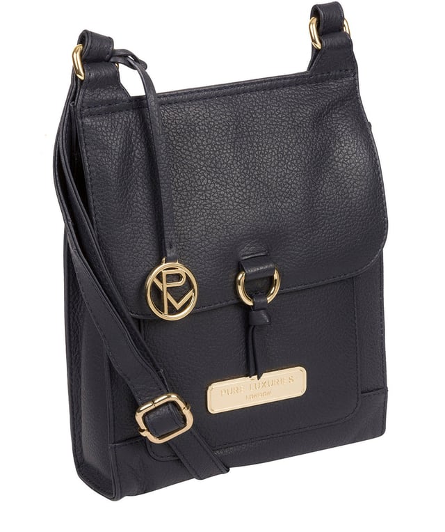 The 'Naomi' cross body bag from Pure Luxuries London is crafted from leather that has a soft pebble grain finish. The fold over top conceals the 100% untreated cotton lined compartment which is complemented by pockets on the interior and exterior of the bag, providing organised storage for all of your essentials. Comes with an adjustable and matching leather strap to suit your needs. Adorned with eye-catching gold coloured fittings and finished with the Pure Luxuries London charm and logo.