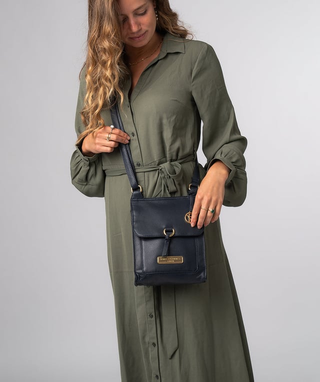 The 'Naomi' cross body bag from Pure Luxuries London is crafted from leather that has a soft pebble grain finish. The fold over top conceals the 100% untreated cotton lined compartment which is complemented by pockets on the interior and exterior of the bag, providing organised storage for all of your essentials. Comes with an adjustable and matching leather strap to suit your needs. Adorned with eye-catching gold coloured fittings and finished with the Pure Luxuries London charm and logo.