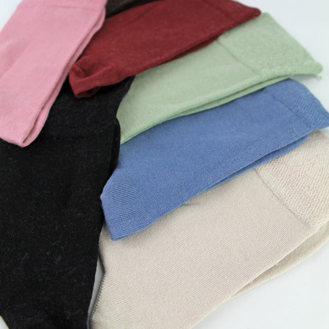 Sock Snob - 6 Pack Ladies Bamboo / Merino Wool Blend Socks: Sock Snob offers a luxurious blend of bamboo and Merino Wool in these Ladies' socks, delivering an exceptional combination of comfort, softness, and warmth. The bamboo fibres provide a silky-smooth feel against the skin, while their natural moisture-wicking properties keep your feet dry and fresh throughout the day. The Merino wool adds an extra layer of warmth, making these socks ideal for year-round wear, whether in the chill of winter or the mild temperatures of spring and autumn. These socks are perfect for everyday use, seamlessly transitioning from a busy day at the office to a relaxed evening at home, all while ensuring your feet remain cosy and comfortable. Whether you're dressing up or keeping it casual, these socks in various colours like Black, Brown, Rose Pink, Sage Green, Denim Blue, Burgundy, and Sand Beige will complement any outfit. They are designed to fit comfortably with Ladies Size 4-8 UK, and they are made from a soft and luxurious material blend: 60% Viscose (from Bamboo), 23% Polyamide, 15% Merino Wool, and 2% Elastane. These socks are also safely machine washable. Extra Product Details: Sock Snob Ladies Casual Socks Super Soft Feel Bamboo & Merino Wool Blend Naturally Moisture Wicking Simple & Plain Design Natural Warmth 6 Pairs Per Pack Ladies One Size: 4-8 UK Machine Washable