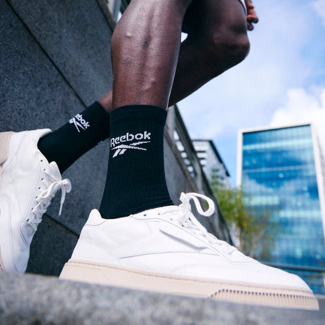 Reebok - 6 Pair Men's & Ladies Core Ribbed Cotton Crew Socks: Reebok Core Ribbed Crew Socks are the perfect addition to your everyday sock collection. With a classic design featuring the iconic Reebok logo, these sporty ribbed leg socks offer a soft, stretchy feel, making them ideal for all-day comfort. The built-in arch support is specially designed to provide a secure, snug fit that conforms to the natural contours of your foot, helping to reduce fatigue and improve stability throughout the day. This makes ribbed socks ideal for maintaining a snug fit around the calf, offering gentle compression that enhances circulation and prevents sagging, which is especially useful during physical activity or long periods of wear. The seamless toe design eliminates the traditional bulky seam found in most socks, reducing the risk of irritation and friction. This feature enhances comfort, particularly during long periods of wear, as it prevents pressure points and chafing around the toes. Ideal for those who prefer an unobtrusive and minimalist style, these socks seamlessly blend into any outfit while maintaining maximum comfort throughout the day. These socks offer a great balance of softness, durability, and flexibility. Available in packs of 6 pairs, they come in Black or White, and three UK sizes: 6-8, 8-10, and 10-12. Made from a breathable cotton blend with 59% Cotton, 36% Polyester, 4% Elastane, and 1% Polyamide they are also machine washable at 40°, making them easy to care for and perfect for everyday wear. Extra Product Details: Reebok Core Crew Socks Arch Support for Snug Fit Cotton Blend Seamless Toe & Cushioned Sole Ribbed Leg for Comfort Available in Black & White Soft and Breathable 6 Pairs Per Pack 3 UK Sizes: 6-8, 8-10, 10-12 Machine Washable