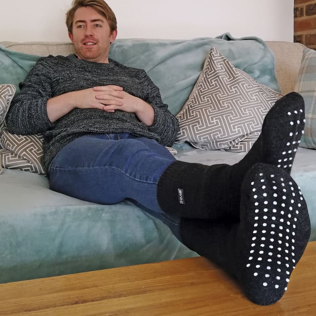 Mens THMO Slipper Socks: THMO thermal slipper socks have been made with a heavy bulk acrylic yarn with extreme thermal qualities. They have been double brushed on the inside to maximise warmth by trapping warm air and keeping it close to your feet. This brushing also softens the inside of the sock making it a great choice for indoor relaxing. These thermal socks also feel like they are seamless with a neat hand-linked toe. The ribbed welt at the top of the sock has been designed to rest to the natural contours of your legs. This wide soft top provides all day comfort and will reduce the chances of nasty constriction rings developing around your legs. The THMO badge is also heat transferred onto the side of the sock. This is the THMO slipper version for the thermal socks. An anti slip grip has been designed onto the foot of the sock in order to prevent you from slipping on surfaces such as hard wooden floors or kitchen tiles. These men's THMO thermal slipper socks are available in 2 colours including black and navy, the grip is a white dotted design. They are a size 6-11 and they are made from 93% Acrylic, 6% Polyamide, 1% Elastane. They are also safely machine washable. Extra Product Details: - THMO - Slipper Socks - Double Brushed - Hand Linked Toe - Ribbed Welt - 1 Pair Pack - 2 Colours to choose between - 6-11 - 93% Acrylic, 6% Polyamide, 1% Elastane