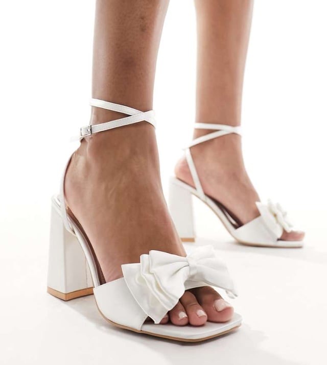 Shoes by Be Mine Wide Fit  Adjustable strap Pin-buckle fastening Bow detail Open toe High point heelSold By: Asos