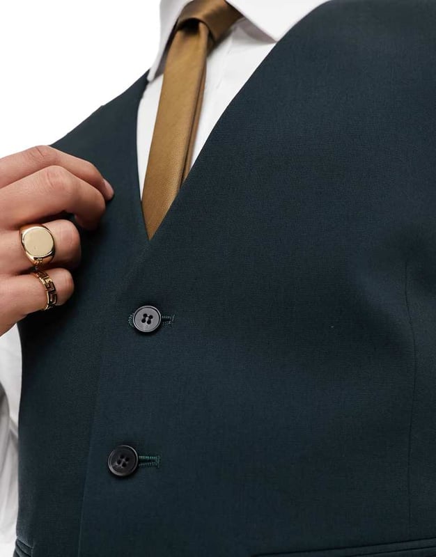 ASOS DESIGN slim suit waistcoat in dark green Suits by ASOS DESIGN Do the smart thing V-neck Button placket Contrast back with an adjustable cinch Slim fitSold By: Asos