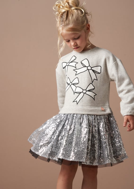 Is it a sweatshirt. is it a dress?… It's both! And it's fabulous! A super soft cotton sweat top with a bow print and a fully embellished   sequin skirt. The perfect hybrid of smart casual.