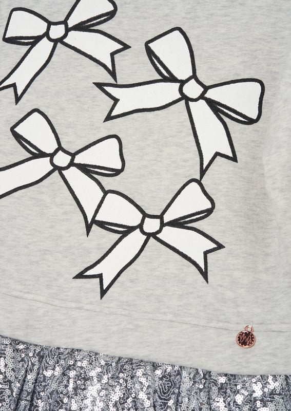 Is it a sweatshirt. is it a dress?… It's both! And it's fabulous! A super soft cotton sweat top with a bow print and a fully embellished   sequin skirt. The perfect hybrid of smart casual.