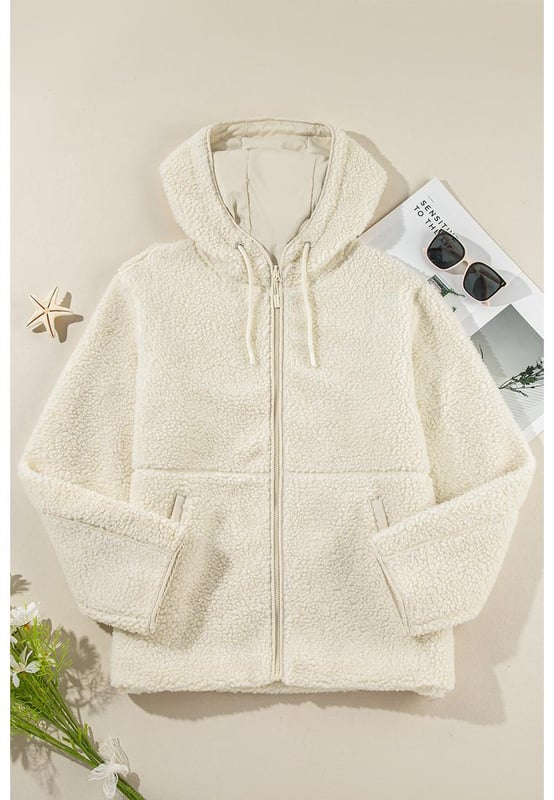 Beige fleece zip
  up jacket
  Adjustable hood with drawstring
  Convenient side pockets
  Versatile for layering or wearing alone
  Perfect for chilly days and cozy nights
Material: 100% Polyester