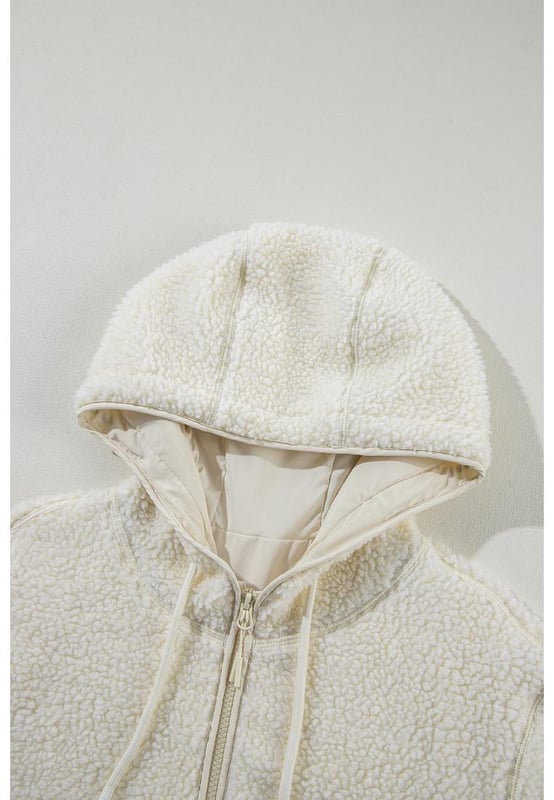 Beige fleece zip
  up jacket
  Adjustable hood with drawstring
  Convenient side pockets
  Versatile for layering or wearing alone
  Perfect for chilly days and cozy nights
Material: 100% Polyester