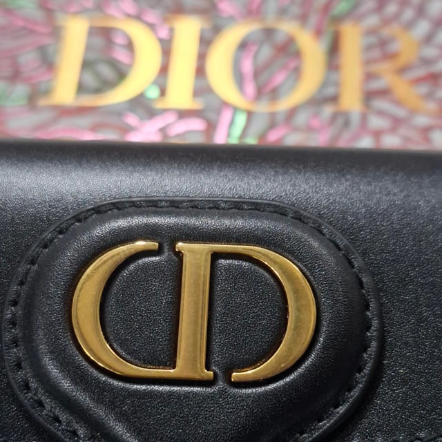 VINTAGE, RRP AS NEW
Timeless elegance in a compact design, the Dior New Dior Bobby Mini Bag in Black Calfskin Leather is a refined take on the classic hobo silhouette. Crafted from luxurious black box calfskin, this mini bag boasts the sophisticated lines and harmonious proportions that define Dior’s iconic style. The antique gold-finish metal details add a vintage charm, while the magnetic clasp with the decorative CD buckle exudes the House’s signature refinement. With a removable and adjustable leather shoulder strap featuring elegant pin buckles, the bag offers versatile styling options – carry it by hand, wear it over your shoulder, or style it crossbody for a laid-back, chic look. Inside, the calfskin and goatskin lining along with an interior slip pocket ensure both beauty and functionality. Whether you're dressing up for an evening out or adding a luxury touch to your day-to-day look, the Dior Bobby Mini Bag is the ultimate accessory for every occasion.



with Box, Dust bag

Dior New Dior Bobby Mini Bag in Black Calfskin Leather
vCondition: Excellent
Signs of wear: No retail tag, No visible sign of wear., 
Packaging: Box, Dust bag
Color: black
Material: Leather | leather
Size: One Size | One Size
Measurements: Width: 170; Height: 100; Length: 170; Handle drop: 0; Strap length: 580
SKU: NAPPUGBBA458696W