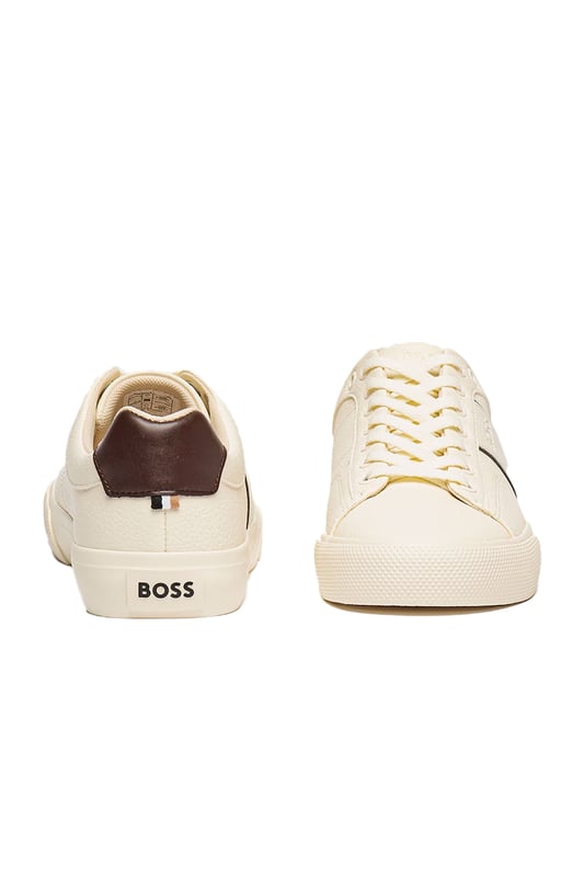 Boss Aiden_tenn_grltp Trainer Natural
100% Leather uppers in a shade of off-white with a contrast Brown heel panel and piping. Subtle embossed BOSS logo sits to the side, these are a timeless pair of trainers that can be easily dressed up or down, integrating effortlessly into any gents wardrboe.

100% Leather Upper
Cupsole construction
Style - 50522833