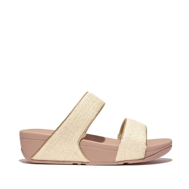 Women's Fit Flop Lulu Shimmerweave Sliders in Stone De Lulu slippers van FitFlop zijn klassiekers. Blijvend populair, ze zijn zacht gevoerd en kunnen omhoog of omlaag gekleed worden. Ze staan op FitFlop's legendarische super dempende Microwobbleboard™ tussenzool. Dit seizoen uitgevoerd in een glinsterende stof met een chique 'tweedy' uitstraling. Afgerand met metallic parelmoeren biezen van imitatieleer voor extra glans. Subtiel glinsterende sandalen die je overal bij kunt dragen en prachtig zijn van dag tot nacht.