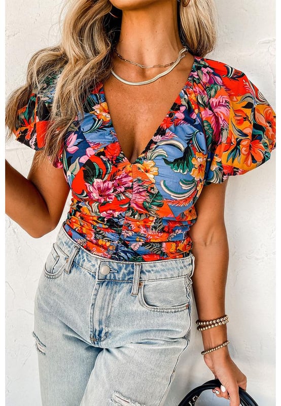 Orange floral print
  Ruched detailing adds texture
  Puff sleeves are on
  trend
  V
  neck design accentuates the neckline
  Captivating floral print for an eye
  catching look
  Available in sizes S M L and XL
Material: 95% Polyester 5% Elastane