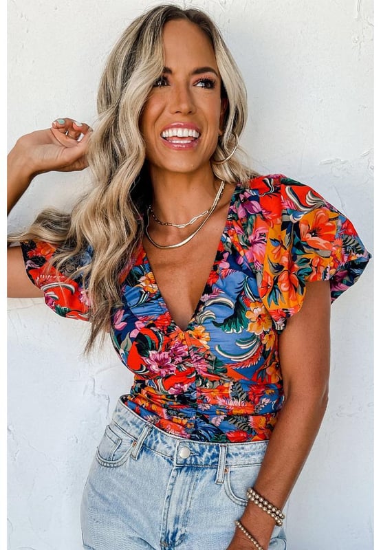 Orange floral print
  Ruched detailing adds texture
  Puff sleeves are on
  trend
  V
  neck design accentuates the neckline
  Captivating floral print for an eye
  catching look
  Available in sizes S M L and XL
Material: 95% Polyester 5% Elastane
