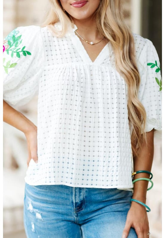 White floral embroidered blouse with puff sleeves
  Lattice design and notched neck
  Relaxed fit for comfortable wear
  Colorful floral embroidery on sleeves
  Suitable for most casual occasions
  Available in different sizes
Material: 100% Polyester
