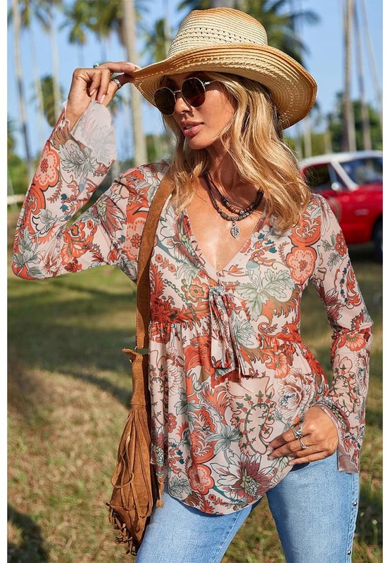 Orange floral print design
  Deep V neck for an elegant neckline
  Front knot detail adds style
  Trendy bell sleeves for a romantic touch
  High elasticity for comfort
  Available in sizes S to XL
Material: 95% Polyester 5% Elastane