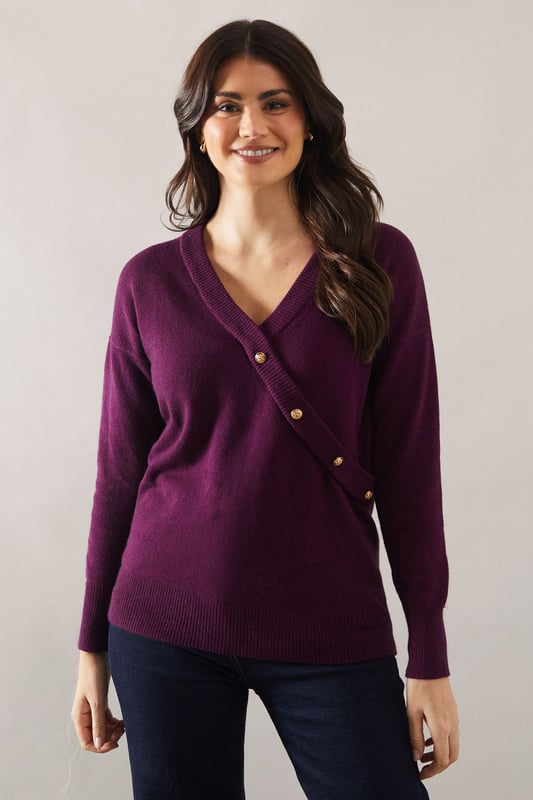 Stylish wrap design with button detail
        V-neckline for a flattering silhouette
        Long sleeves for versatile wear
        Slouchy fit offering comfort and style
        Ribbed cuffs and hem for a polished finish
    
    Embrace effortless sophistication with this button detail wrap slouchy jumper from Wallis. The wrap design, accentuated by eye-catching buttons, adds a touch of elegance to your everyday wardrobe. Its relaxed fit ensures comfort without compromising on style, making it perfect for various casual occasions. Pair it with your favourite jeans and ankle boots for a chic daytime look, or layer it over a collared shirt for a smart-casual ensemble. The versatility of this jumper shines through at family gatherings or lunch dates with friends. For a cosy yet put-together appearance, team it with wide-leg trousers and loafers. This Wallis jumper is a testament to the brand's commitment to blending comfort with glamour, ensuring you feel confident and stylish for any casual event.