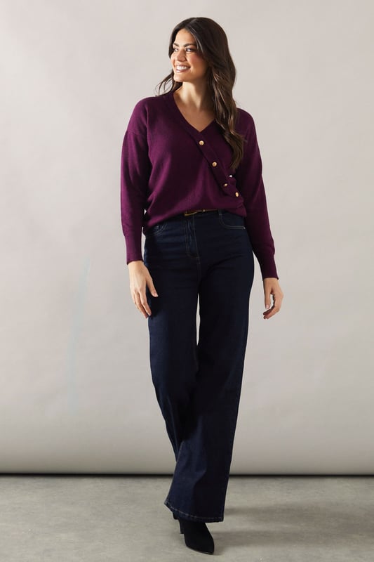 Stylish wrap design with button detail
        V-neckline for a flattering silhouette
        Long sleeves for versatile wear
        Slouchy fit offering comfort and style
        Ribbed cuffs and hem for a polished finish
    
    Embrace effortless sophistication with this button detail wrap slouchy jumper from Wallis. The wrap design, accentuated by eye-catching buttons, adds a touch of elegance to your everyday wardrobe. Its relaxed fit ensures comfort without compromising on style, making it perfect for various casual occasions. Pair it with your favourite jeans and ankle boots for a chic daytime look, or layer it over a collared shirt for a smart-casual ensemble. The versatility of this jumper shines through at family gatherings or lunch dates with friends. For a cosy yet put-together appearance, team it with wide-leg trousers and loafers. This Wallis jumper is a testament to the brand's commitment to blending comfort with glamour, ensuring you feel confident and stylish for any casual event.