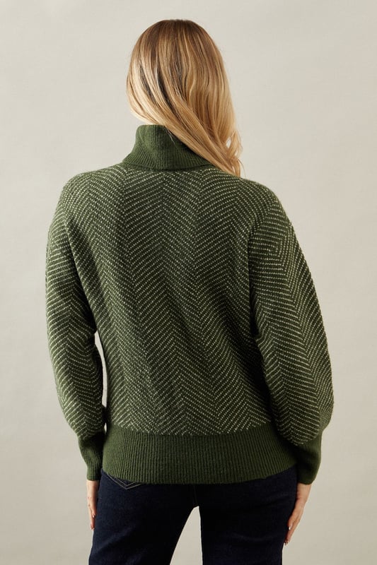 Striking chevron stitch pattern adds visual interest
        Cosy roll neck design for extra warmth
        Relaxed fit with dropped shoulders for comfort
        Ribbed cuffs and hem for a snug finish
        Versatile knit suitable for various occasions
    
    Embrace sophistication and comfort with this exquisite Chevron Stitch Roll Neck Jumper from Wallis. The eye-catching chevron pattern radiates elegance, while the roll neck design offers both style and warmth. Perfect for those chilly autumn days or cosy winter evenings, this jumper effortlessly transitions from day to night. Pair it with dark wash jeans and ankle boots for a casual yet polished look, ideal for family gatherings or weekend brunches. For a more refined ensemble, team it with tailored trousers and heeled loafers, making it suitable for informal work settings or dinner dates. The relaxed fit ensures ease of movement, while the textured knit adds a touch of luxury to your wardrobe. This versatile piece is a must-have for the fashion-conscious woman who values both style and comfort in her everyday attire.
