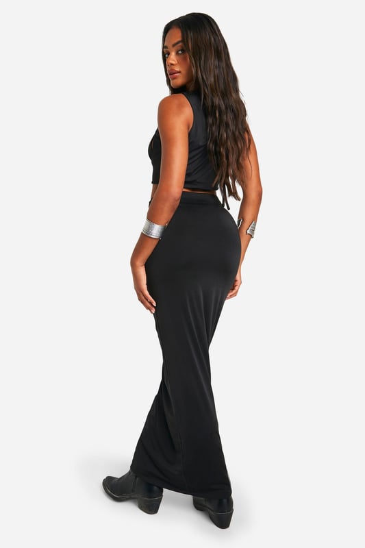 Daring cut-out design with O-ring details
        Floor-sweeping maxi length for dramatic flair
        Figure-hugging silhouette accentuates curves
        Ruched detailing at the waist for added texture
        Versatile piece suitable for various evening events
    
    Make a bold statement at your next festival or night out with this eye-catching cut-out maxiskirt. The daring design features strategically placed O-ring details that add an edgy touch to your ensemble. The figure-hugging silhouette and floor-sweeping length create a striking look that's sure to turn heads. Style it with a cropped top and chunky boots for a festival-ready outfit, or pair it with strappy heels and statement jewellery for a night on the town. The ruched detailing at the waist adds texture and interest, while also flattering your figure. This versatile piece can be dressed up or down, making it a must-have addition to your wardrobe for various evening occasions. Whether you're dancing the night away or enjoying drinks with friends, this maxiskirt will help you project confidence and style.