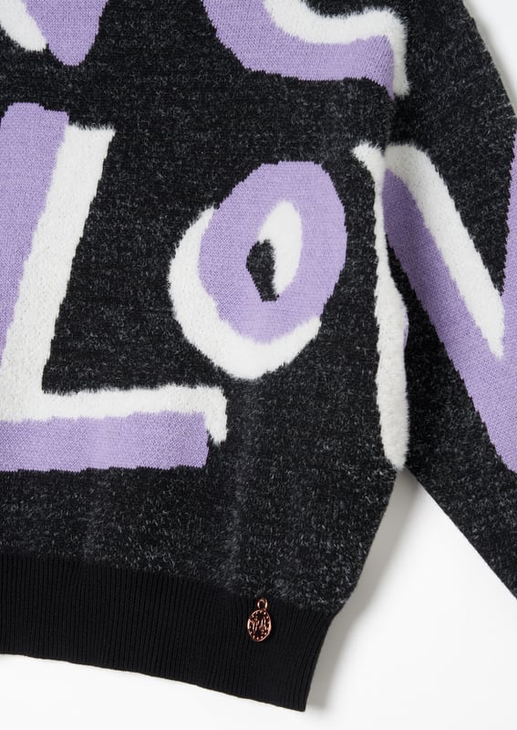 Love is our new fluffy slogan knit! Crafted from the softest monochrome yarn. highlighted with lilac and cut into a relaxed silhouette. Style with anything for wearable optimism!.