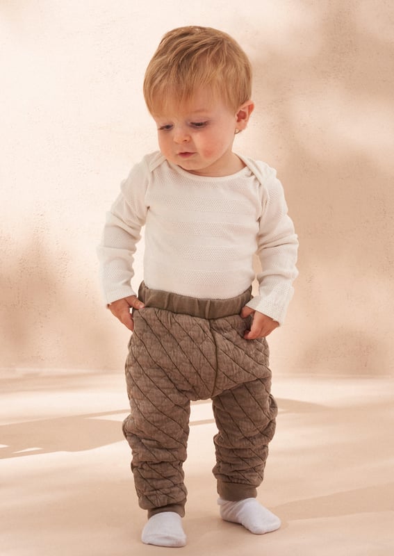 Your daily dose of cuteness! A soft and cosy baby outfit featuring a washed jersey onesie and super soft quilted trouser. perfect for keeping your little one comfortable and stylish.