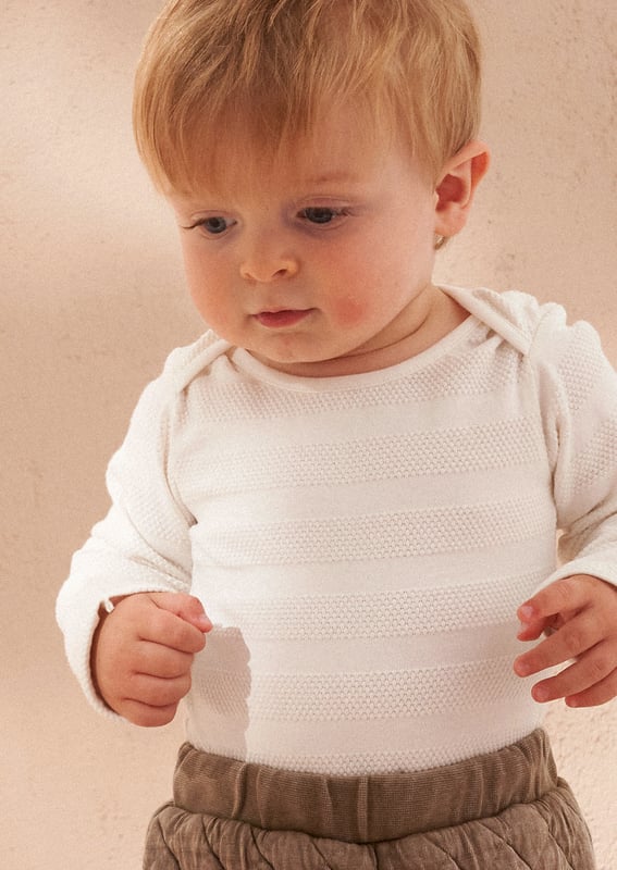Your daily dose of cuteness! A soft and cosy baby outfit featuring a washed jersey onesie and super soft quilted trouser. perfect for keeping your little one comfortable and stylish.