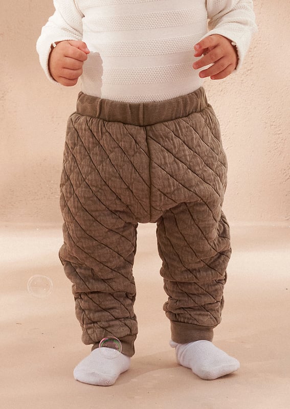Your daily dose of cuteness! A soft and cosy baby outfit featuring a washed jersey onesie and super soft quilted trouser. perfect for keeping your little one comfortable and stylish.