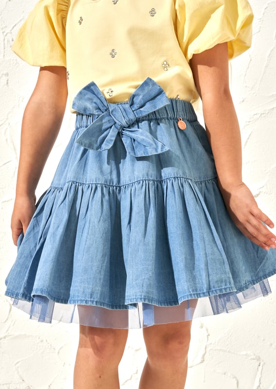 Achieve the maximum twirl factor in this super flippy cotton ra-ra skirt. Multi layers of soft chambray and mesh ensure the skirt is super full and the oversize bow make it extra cute. It's Tutu good!. About Me: 100% Cotton. Look After Me: Think Planet. Wash At 30C.