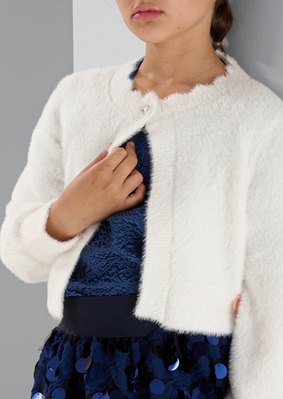 The perfect cover up. A super soft fluffy knit in classic off   finished with the prettiest diamante buttons.Snuggly and stylish in equal measure.. About Me: 100% Nylon. Look After Me: Think Planet. Wash At 30C.