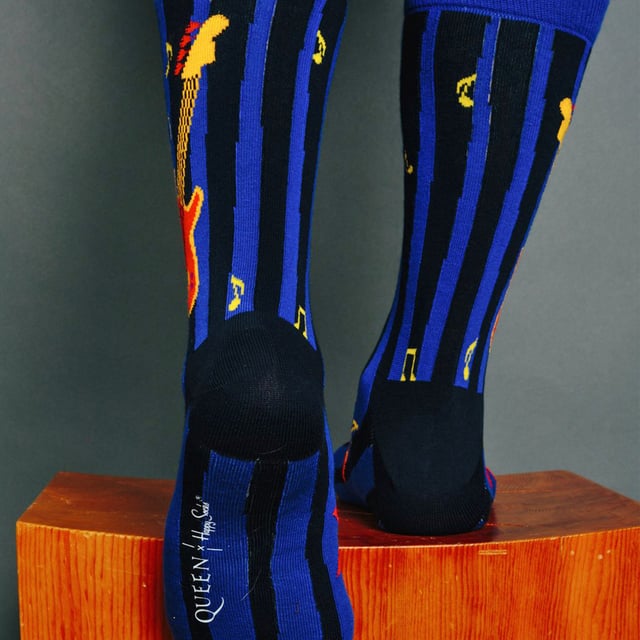 Happy Socks Queen Socks: Happy Socks are a popular brand providing a high-quality sock that combines unique designs and craftsmanship. Mikael Söderlindh and Viktor Tell had a vision to spread happiness by turning an everyday essential into a colorful design piece. In 2008, socks were just socks. White, grey and black pieces of textile that were nowhere close to the fashionable and creative design piece they could become. The world’s most comfortable and colorful tool for spreading happiness was born. This concept is now brought to life by Happy Socks’ talented team of creatives. Today, Happy Socks has reached 90 countries and every continent. With Concept Stores all around the world, from LA to Tokyo, Happy Socks can be found in over 10,000 top fashion apparel boutiques. These socks are made from a soft, high quality combed cotton rich blend and in a fine gauge knit for versatile wear. Finished with a comfortable smooth toe seam, these socks feature standard cuffs, and are officially licensed limited edition socks. They come in a pack of 1 pair. They are machine washable at 40. They are made from 86% Cotton 12% Polyamide 2% Elastane. Extra Product Details: - Queen Socks by Happy Socks - Bohemian Rhapsody - We Will Rock You - Radio Ga Ga Socks - Colour Block Design - Unique and Funky Patterns - 1 Pair Pack - Machine washable at 40 - 86% Cotton 12% Polyamide 2% Elastane.