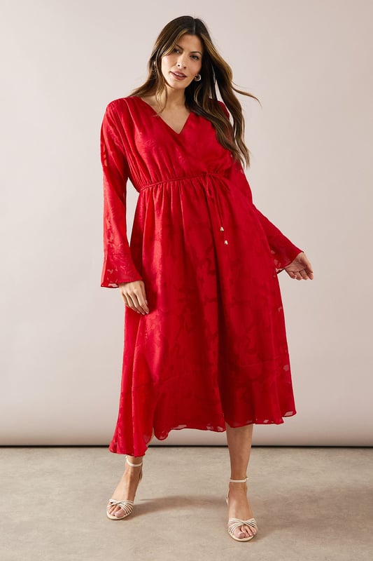 Elegant floral jacquard fabric adds texture and sophistication
        Flattering wrap neckline for a feminine silhouette
        Dramatic flute sleeves create a romantic flair
        Midi length offers versatility for various occasions
        Cinched waist design accentuates your figure
    
    Embrace effortless glamour with this stunning floral jacquard midi dress from Wallis. The wrap neckline and cinched waist work in harmony to create a flattering silhouette that's both comfortable and chic. The flute sleeves add a touch of drama, perfect for those who love to make a statement. Ideal for family gatherings or casual events, this dress can be easily dressed up or down. Pair it with strappy sandals and delicate jewellery for a daytime look, or switch to block heels and a clutch bag for evening drinks. The midi length offers practicality without compromising on style, making it a versatile addition to your wardrobe. Whether you're heading to a garden party or a casual dinner, this Wallis dress will ensure you look polished and feel confident.