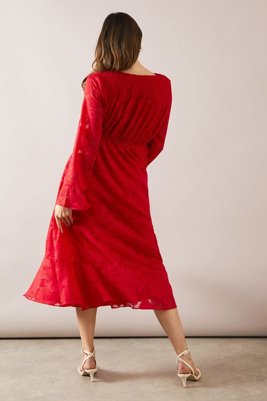 Elegant floral jacquard fabric adds texture and sophistication
        Flattering wrap neckline for a feminine silhouette
        Dramatic flute sleeves create a romantic flair
        Midi length offers versatility for various occasions
        Cinched waist design accentuates your figure
    
    Embrace effortless glamour with this stunning floral jacquard midi dress from Wallis. The wrap neckline and cinched waist work in harmony to create a flattering silhouette that's both comfortable and chic. The flute sleeves add a touch of drama, perfect for those who love to make a statement. Ideal for family gatherings or casual events, this dress can be easily dressed up or down. Pair it with strappy sandals and delicate jewellery for a daytime look, or switch to block heels and a clutch bag for evening drinks. The midi length offers practicality without compromising on style, making it a versatile addition to your wardrobe. Whether you're heading to a garden party or a casual dinner, this Wallis dress will ensure you look polished and feel confident.