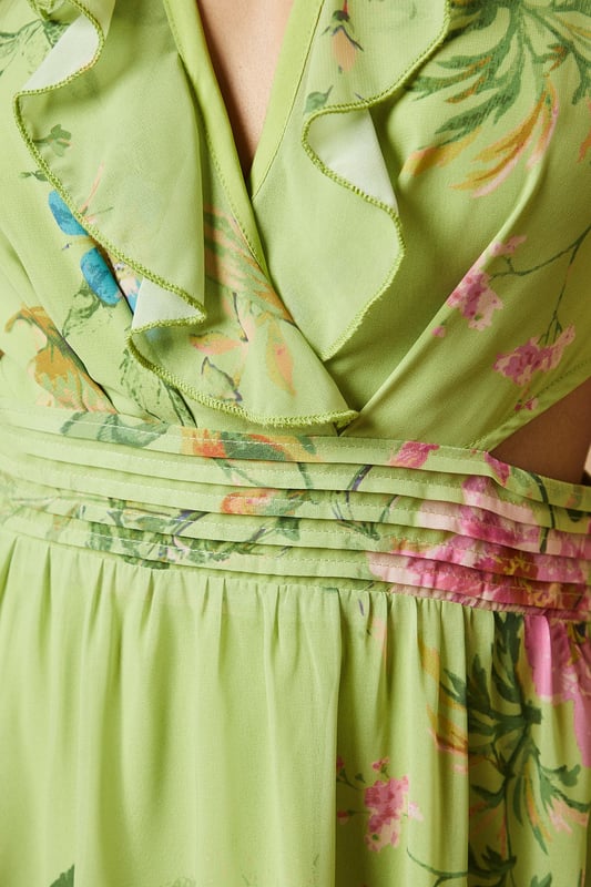 Enchanting floral print midi dress
        Flattering V-neckline with ruffle detail
        Long sleeves with elegant cuffs
        Cinched waist with matching fabric belt
        Stylish cut-out detail at the back
    
    Embrace the essence of feminine charm with this captivating printed midi dress from Oasis. The flowing chiffon fabric creates a graceful silhouette, while the vibrant floral pattern adds a touch of whimsy to your ensemble. Perfect for daytime events, this versatile piece can be styled for various casual occasions. Pair it with strappy sandals and a woven bag for a relaxed garden party look, or dress it down with white trainers and a denim jacket for a leisurely weekend brunch. The cut-out detail at the back adds a subtle hint of allure, making this dress a standout choice for family gatherings or afternoon tea with friends. Accessorise with delicate gold jewellery to complement the dress's romantic appeal and create a look that's both effortless and sophisticated.