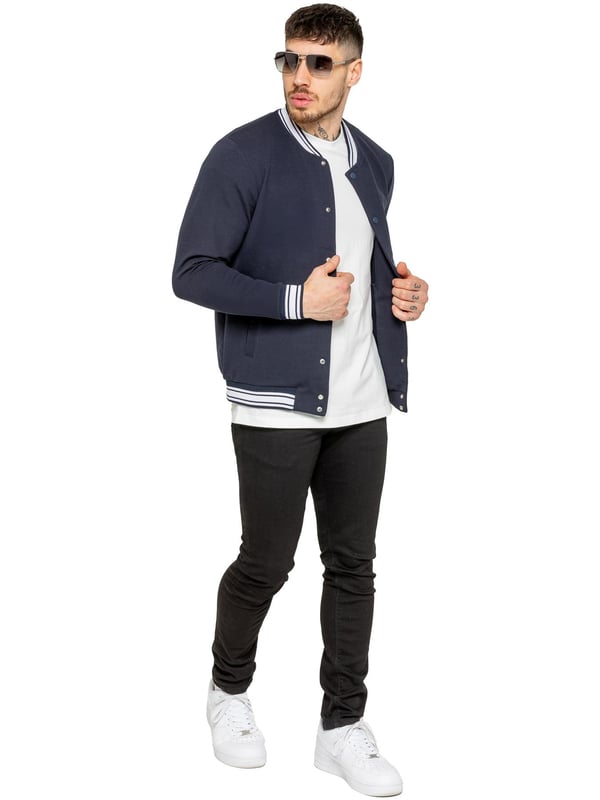 The Enzo Milano Men's Bomber Jacket combines classic style with modern comfort. Designed in a regular fit, it features a stretch fabric for ease of movement and all-day comfort. The contrast-tipped ribbed collar and cuffs add a stylish touch, while the popper fastening ensures easy wear. With two practical pockets and ribbed trims for a snug fit, this versatile jacket is perfect for any casual or smart-casual look.(35)