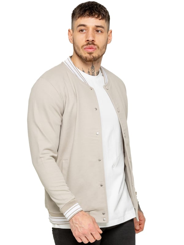 The Enzo Milano Men's Bomber Jacket combines classic style with modern comfort. Designed in a regular fit, it features a stretch fabric for ease of movement and all-day comfort. The contrast-tipped ribbed collar and cuffs add a stylish touch, while the popper fastening ensures easy wear. With two practical pockets and ribbed trims for a snug fit, this versatile jacket is perfect for any casual or smart-casual look.(35)