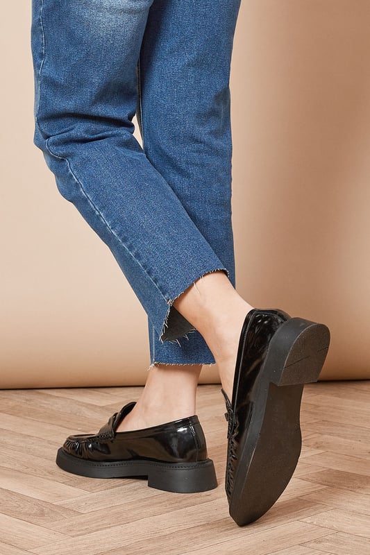 Faux patent leather upper for a glossy, polished look
        Chunky sole design for added height and comfort
        Classic loafer silhouette with a modern twist
        Flat heel between 0 and 2cm for all-day wearability
        Versatile neutral tone suitable for various outfits
    
    Step out in style with the Faith Helia Faux Patent Leather Chunky Loafers, a perfect blend of classic design and contemporary flair. These eye-catching flats boast a sleek, glossy finish that adds a touch of sophistication to any ensemble. The chunky sole not only provides a subtle height boost but also ensures comfort for extended wear. Ideal for the fashion-forward individual, these loafers can effortlessly transition from day to night. Pair them with cropped jeans and a crisp white shirt for a chic daytime look, or style them with a flowing midi dress for a more relaxed evening outfit. Whether you're heading to a casual lunch date, running errands, or meeting friends for coffee, these versatile loafers will keep you looking polished and feeling comfortable throughout your day.