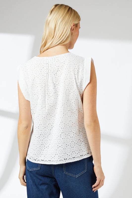 Intricate pintuck detailing adds texture and dimension
        Delicate broderie anglaise pattern throughout
        Sleeveless design with subtle flutter at the shoulders
        Keyhole neckline with tie closure for adjustable fit
        Versatile crew neckline suits various styling options
    
    This charming Principles blouse radiates effortless elegance with its intricate pintuck detailing and all-over broderie anglaise pattern. The sleeveless design, featuring a subtle flutter at the shoulders, offers a breezy feel perfect for warm-weather outings. Style this versatile piece for a range of casual occasions, from weekend brunches to family gatherings. Pair it with wide-leg trousers and sandals, as shown, for a relaxed yet put-together look. Alternatively, tuck it into a flowing midi skirt and add espadrilles for a garden party-ready ensemble. The keyhole neckline with tie closure allows for customisable comfort, while the crew neckline provides a classic foundation for layering delicate necklaces. This blouse's ability to transition seamlessly from day to evening makes it a wardrobe essential for the fashion-forward woman seeking both style and practicality in her everyday attire.
