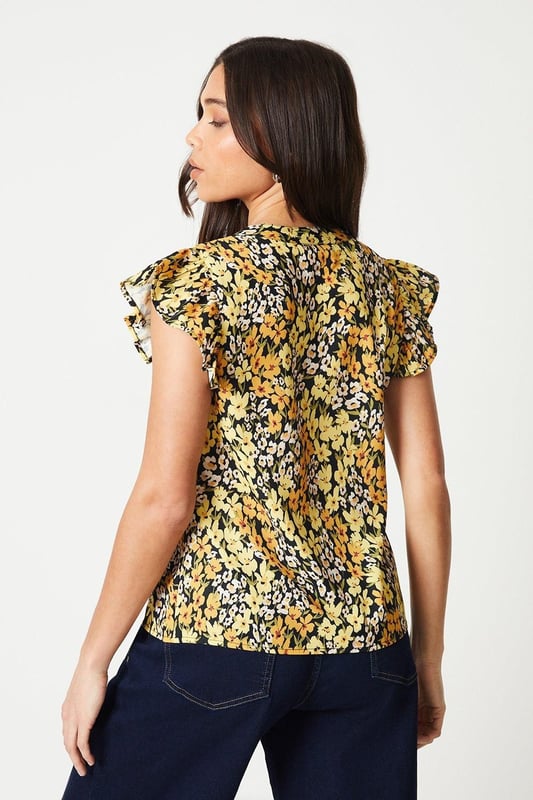 Floral printed woven top with a button-front design
Flattering ruffle trim along the neckline and cap sleeves
Relaxed fit through the body for effortless styling
Lightweight and breathable fabric for warm weather wear
Versatile length that can be tucked or left untucked

This petite floral top from Dorothy Perkins exudes a charming, feminine aesthetic that's perfect for smart casual occasions. The vibrant print and ruffle detailing add a touch of playfulness, while the button-front design lends a polished look. Pair it with tailored trousers or a pencil skirt for a sophisticated brunch ensemble, or dress it down with denim for a more relaxed vibe. Its versatility makes it an ideal choice for baby showers, afternoon teas, or any event where you want to look stylish yet comfortable.