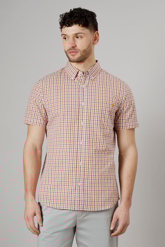 Vibrant check pattern for a stylish summer look
        Short sleeves for optimal comfort in warm weather
        Button-down collar for a smart-casual appearance
        Chest pocket adds a functional touch
        Versatile woven fabric suitable for various occasions
    
    Embrace the essence of laid-back sophistication with this eye-catching Helios check shirt from Maine. The striking pattern adds a dash of personality to your wardrobe, making it an ideal choice for casual outings and relaxed social gatherings. Style it effortlessly with light-coloured chino shorts and white trainers for a fresh summer ensemble. For a more polished look, pair it with tailored trousers and loafers. The short sleeves and breathable cotton fabric ensure you stay cool and comfortable, whether you're enjoying a family barbecue or meeting friends for a leisurely brunch. This versatile shirt transitions seamlessly from day to night, making it a must-have addition to your casual wardrobe. Layer it over a plain white t-shirt for added dimension, or wear it unbuttoned over a vest for a relaxed beach-ready look.