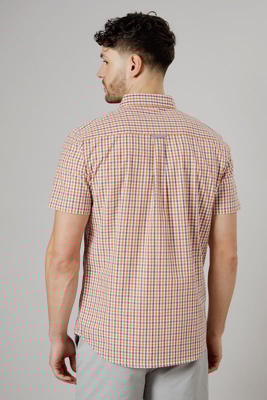 Vibrant check pattern for a stylish summer look
        Short sleeves for optimal comfort in warm weather
        Button-down collar for a smart-casual appearance
        Chest pocket adds a functional touch
        Versatile woven fabric suitable for various occasions
    
    Embrace the essence of laid-back sophistication with this eye-catching Helios check shirt from Maine. The striking pattern adds a dash of personality to your wardrobe, making it an ideal choice for casual outings and relaxed social gatherings. Style it effortlessly with light-coloured chino shorts and white trainers for a fresh summer ensemble. For a more polished look, pair it with tailored trousers and loafers. The short sleeves and breathable cotton fabric ensure you stay cool and comfortable, whether you're enjoying a family barbecue or meeting friends for a leisurely brunch. This versatile shirt transitions seamlessly from day to night, making it a must-have addition to your casual wardrobe. Layer it over a plain white t-shirt for added dimension, or wear it unbuttoned over a vest for a relaxed beach-ready look.