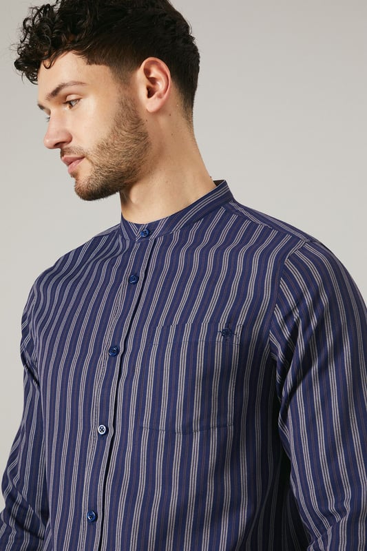 Distinctive grandad collar for a modern twist
        Vertical stripes create a slimming effect
        Long sleeves with button cuffs for versatility
        Convenient chest pocket for small essentials
        Relaxed fit for all-day comfort
    
    This Maine grandad collar shirt offers a contemporary take on casual style. The vertical stripes elongate the silhouette, while the relaxed fit ensures comfort for various body types. Perfect for laid-back weekends or casual Fridays at the office, this shirt can be styled effortlessly with dark denim jeans and white trainers for a smart-casual look. Layer it under a lightweight jacket for cooler evenings or wear it open over a plain t-shirt for a more relaxed vibe. The versatile design makes it suitable for family gatherings, pub outings with mates, or casual dates. The grandad collar adds a touch of sophistication, allowing you to dress it up with chinos and loafers for semi-formal occasions. Easy to care for and comfortable to wear, this shirt is set to become a staple in your wardrobe, offering endless styling possibilities for the modern British gent.