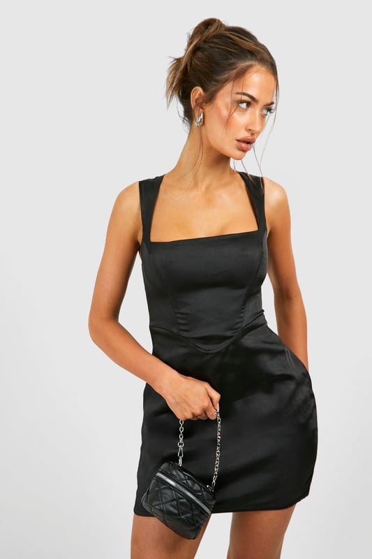 Satin Square Neck Corset Mini Dress Sleek satin mini dress with a chic square neckline
Figure-hugging silhouette accentuates curves
Wide shoulder straps offer comfortable support
Versatile design suitable for various evening occasions
Smooth, lustrous fabric adds a touch of glamour
Make a statement in this alluring satin mini dress, perfect for those nights out when you want to turn heads. The square neckline adds a contemporary twist to the classic bodycon silhouette, while the wide straps ensure you can dance the night away in comfort. Style it with strappy heels and statement earrings for a look that radiates confidence. Whether you're hitting the club scene or enjoying cocktails at a trendy bar, this dress is your go-to for urban nightlife adventures. For a more laid-back vibe, throw on a leather jacket and ankle boots. The dress's versatility allows for endless styling options, making it a must-have piece for the fashion-forward woman who loves to showcase her individuality whilst staying on-trend.