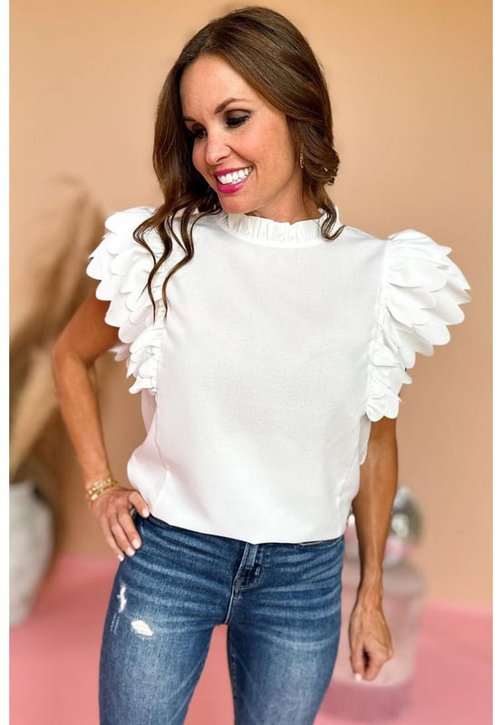 White solid color top
  Scalloped ruffle sleeves add volume and dimension to your arms
  Frilled neck adds a charming and romantic touch to the overall design
  Solid color offers versatility and easy coordination with various bottoms and accessories
  Timeless and polished look that can be dressed up or down for any occasion
  Unisex top comes in different sizes
Material: 100% Polyester
